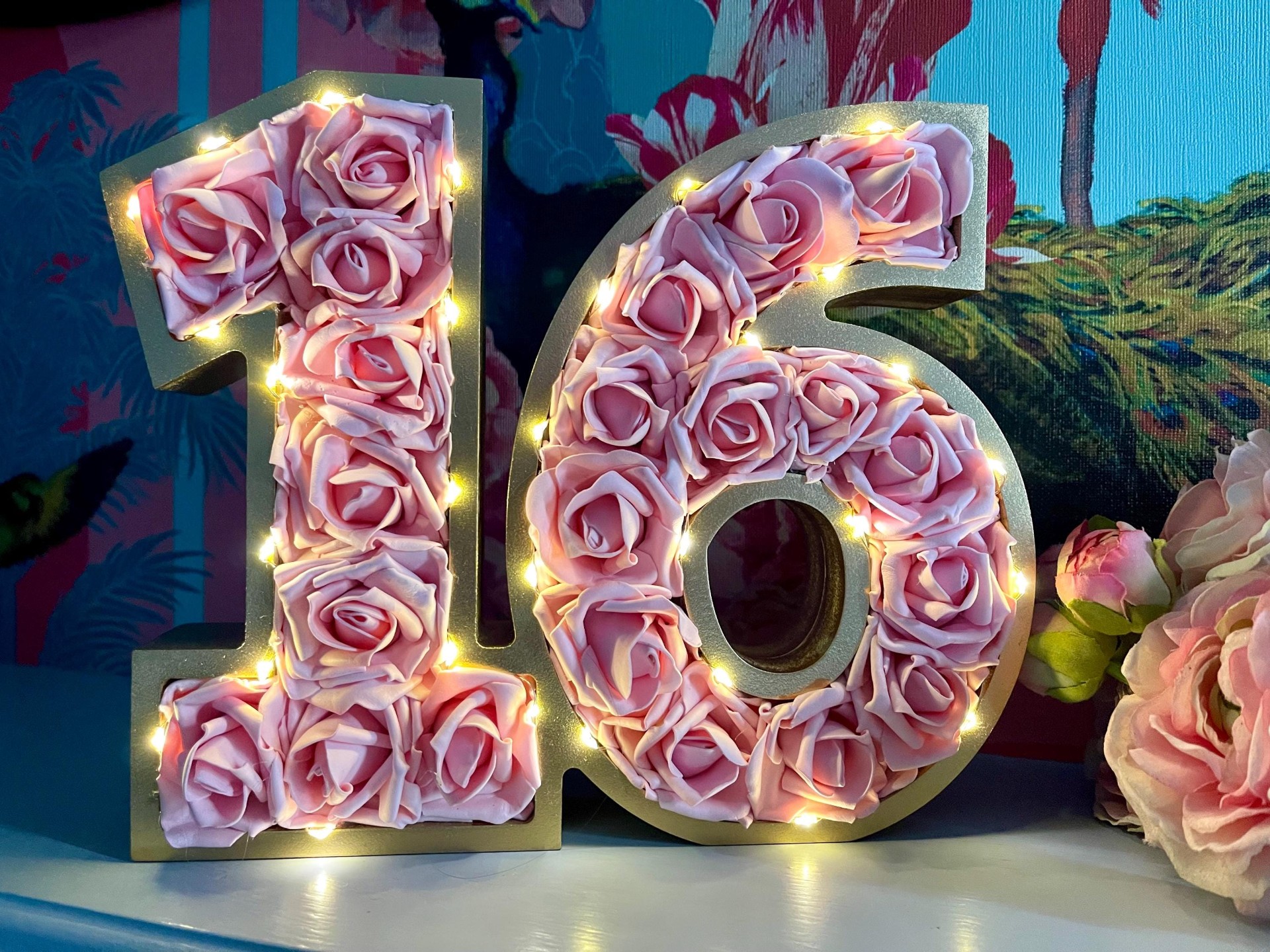 Sweet 16 celebration decor with lit marquee numbers