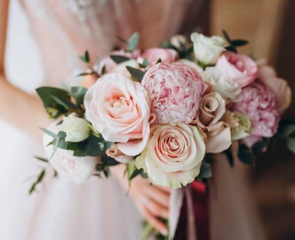 Bride holding a soft pink and white bridal bouquet