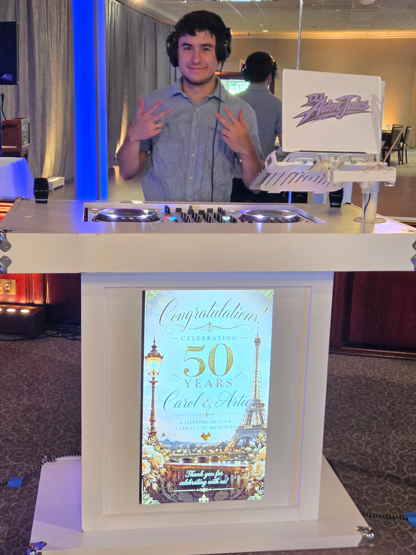 Anniversary celebration DJ booth with custom signage