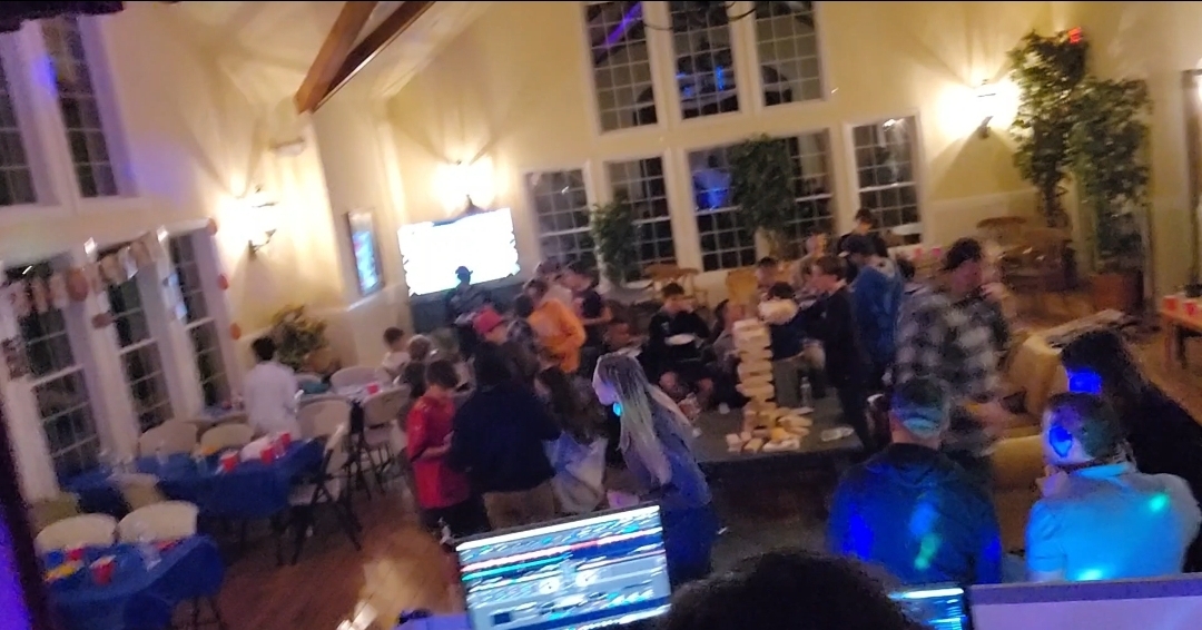 Children dancing with glow bracelets at an indoor birthday party